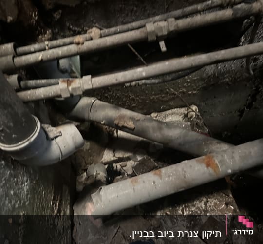 צינורות מתכת חלודים ומחוברים בקיר